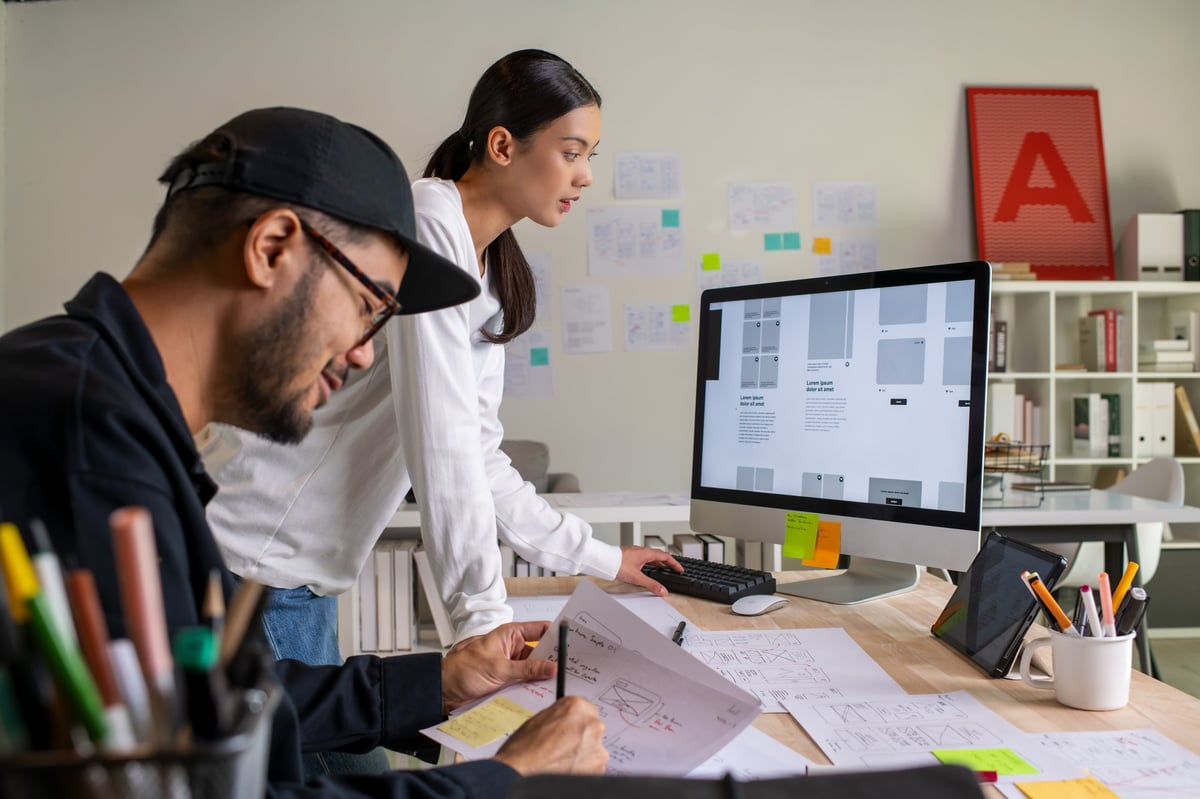UX UI designers discussing and brainstorming on wireframes for website and mobile app